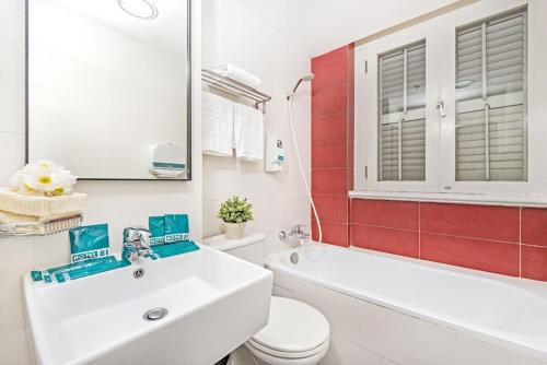 a bathroom with a white sink and a toilet at Hotel 81 Heritage in Singapore