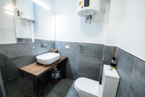 a bathroom with a sink and a toilet at ITALIA HOUSE TORTELLINOSUITE Modena in Modena