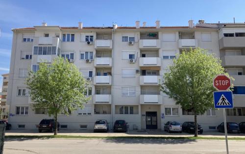 an apartment building with a stop sign in front of it at Apartman Senjak in Pirot