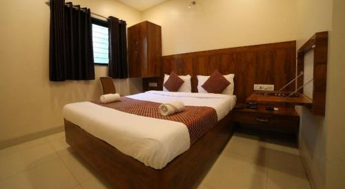 a bedroom with a large bed in a room at New Prakash Intl Airport in Mumbai
