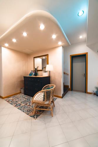 un soggiorno con una sedia e uno specchio di Hotel Del Corso a Bibione