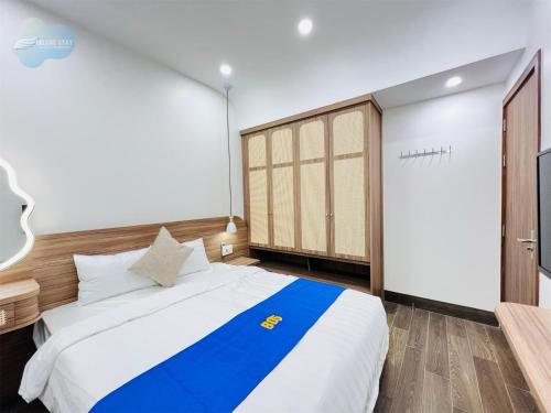 a bedroom with a large bed and a closet at Villa Sonasea Vân Đồn by Deluxe Stay in Cái Rồng