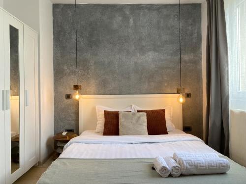 a bedroom with a large bed with two towels on it at Old Town Overlooking - Vibrant 2BR Apartment in Bucharest