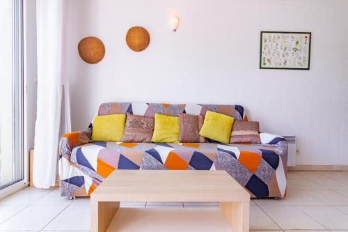 uma sala de estar com um sofá e uma mesa de centro em Le Jouarres - Appt climatisé avec piscine partagée em Azille