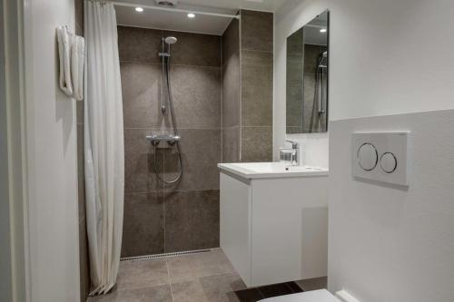 a bathroom with a shower and a sink at Stylish Flat on Lively Street in Downtown in Copenhagen
