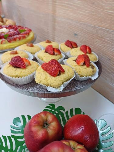 a bunch of cupcakes with strawberries on top of them at La Casa di Linda in Mirano