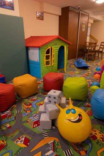a childs play room with a toy house and balls at Aparthotel Bellamonte in Zakopane