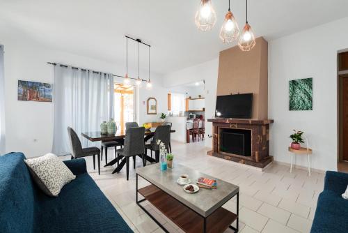 a living room with a blue couch and a table at Villa Perla in Lardos