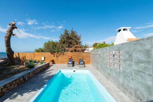 a swimming pool in the backyard of a house at Villa Perla in Lardos