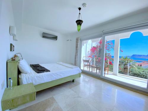 a bedroom with a bed and a large window at Akdeniz Villa in Kas