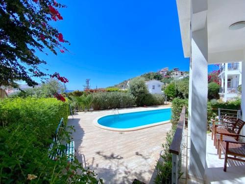 a view of a swimming pool in a yard at Akdeniz Villa in Kas