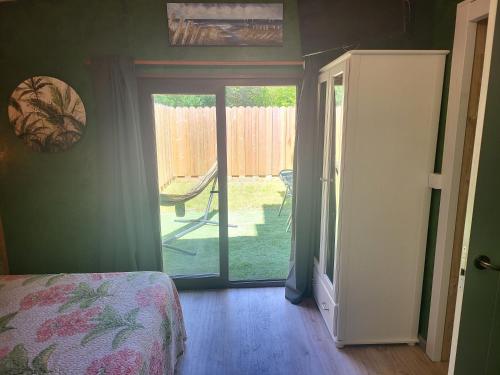 1 dormitorio con puerta que da a un patio en el BOSQUE MAGICO, en Piñeres