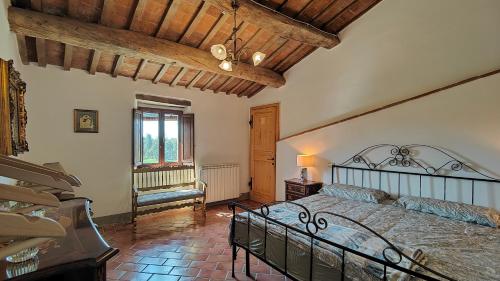 a bedroom with a bed and a wooden ceiling at Casale Alcinoo - Rustico in Tuoro sul Trasimeno