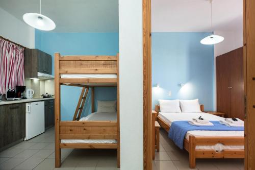 a bedroom with a bunk bed and a kitchen at Kalami apartment with seaview in Falasarna