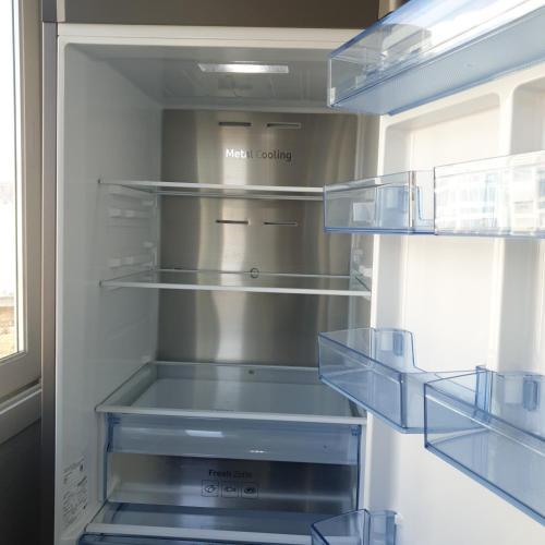 an open refrigerator with empty shelves in it at Stay Haneul in Gimhae