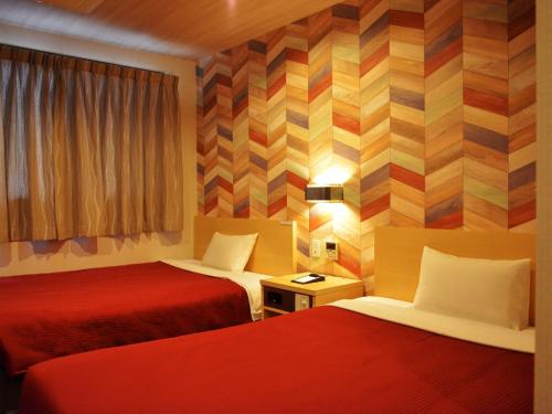 Katil atau katil-katil dalam bilik di Hotel New Gaea Yakuin