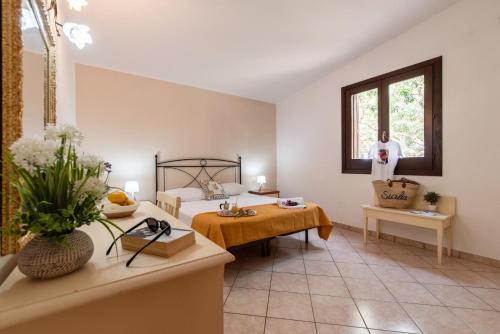 a large room with a bed and a table at Villa Minoa con piscina in San Vito lo Capo