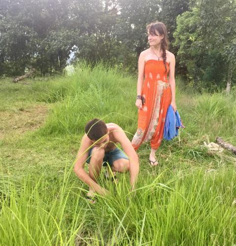a girl standing next to a boy in the grass at Mount fuji homestay in Deorāli