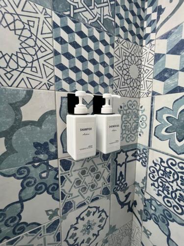 a bathroom with blue and white tiles on the wall at Casa Positano in Positano