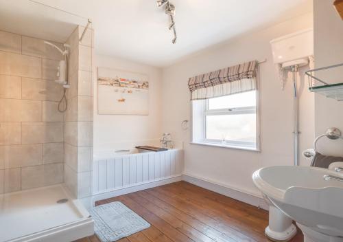 a bathroom with a shower and a sink at Woodcocks in Docking