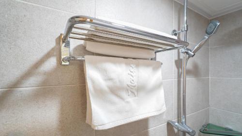 a towel rack in a bathroom with a white towel at 천지연크리스탈 하버39호텔 in Seogwipo