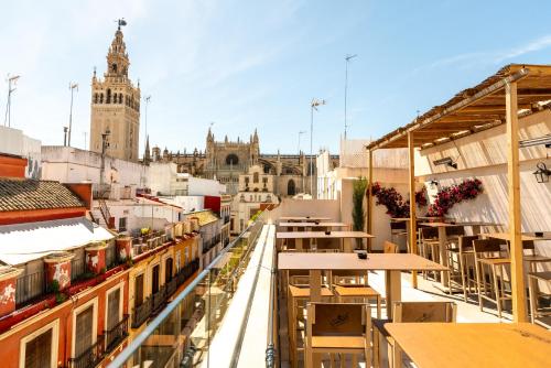 a view of a city with buildings and tables at Arco de la Seda - Hotel Boutique in Seville