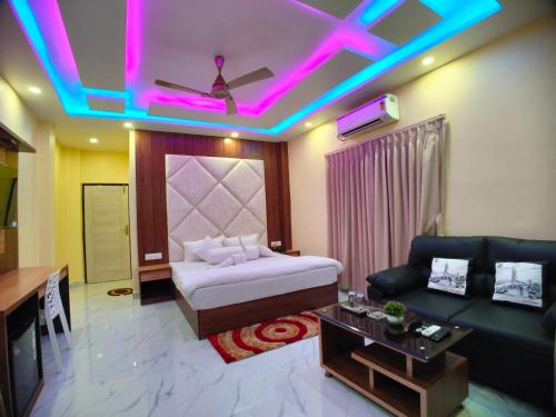 a living room with a bed and a couch at The Triton Beach Resort in Mandarmoni
