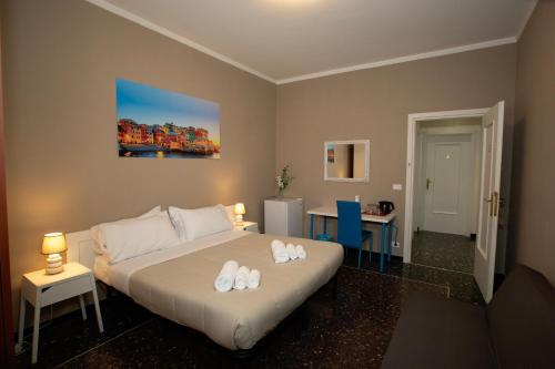a bedroom with a bed with two white towels on it at Casa Vittoria di San Martino Affittacamere in Genova