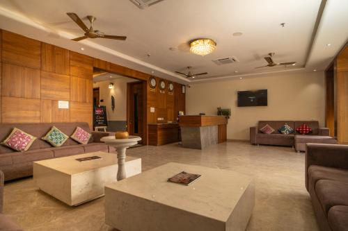RABBIT RATNAM -By Udaipur Hotels في أودايبور: غرفة معيشة مع كنب وطاولة قهوة