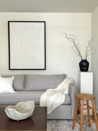 a living room with a gray couch and a table at North Beach Retreat in Atlantic City