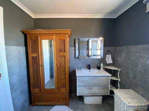 a bathroom with a sink and a mirror at 10 Summerplace in Knysna