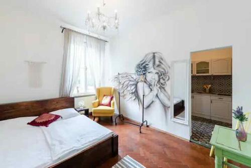 a bedroom with a bed and a drawing on the wall at Angel apartman in Bratislava
