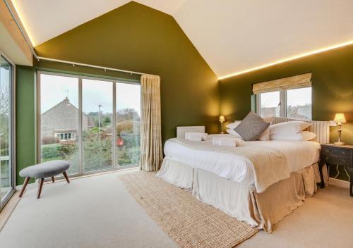a bedroom with a large bed and a large window at Langham Lodge in Langham