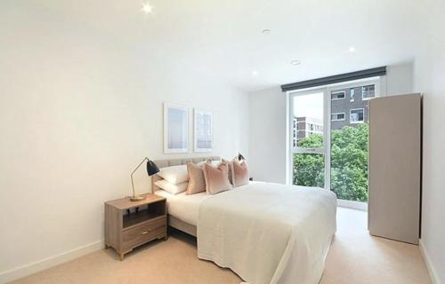 a white bedroom with a bed and a window at Luxury Collection - London Bridge in London
