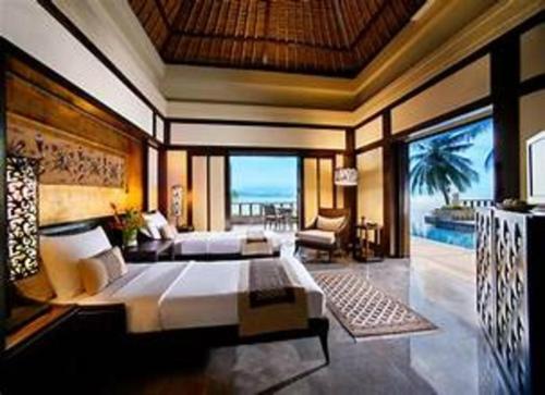 a bedroom with a bed and a view of the ocean at hotel jaguar in Jaffna