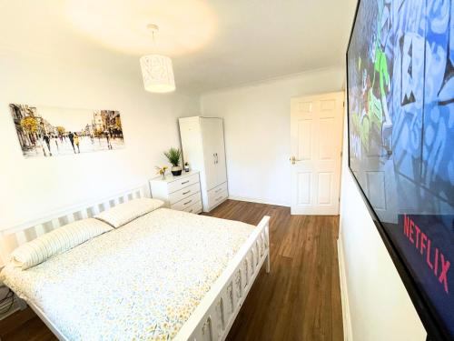 a bedroom with a bed and a tv in it at A Lovely Home Stay Near Greenwich in London