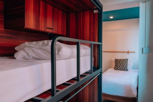 a bedroom with two bunk beds in a room at Malacuna Liverpool in Liverpool