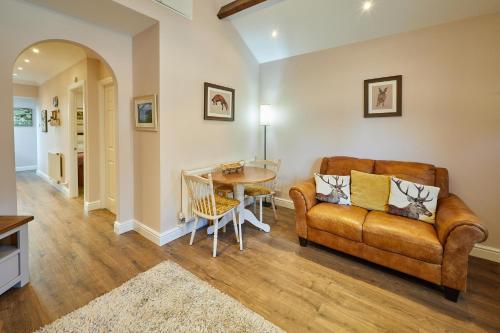 a living room with a couch and a table at Central Ripon - Sleeps 3 - Garden - Pet Friendly in Ripon