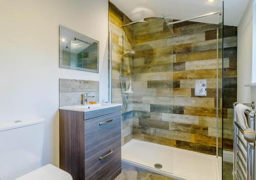 a bathroom with a shower and a sink at Alexandra Cottage in Sheringham