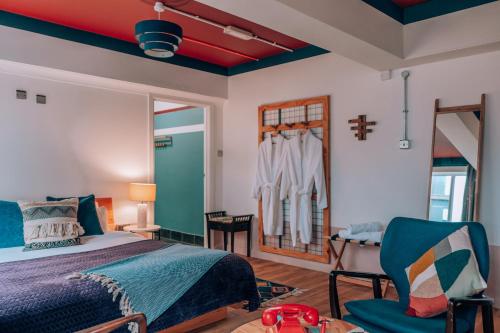 a bedroom with a bed and a chair at Malacuna Liverpool in Liverpool