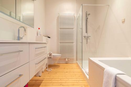 een badkamer met een toilet, een wastafel en een douche bij Spacious Belle Epoque House with free parking in Oostende