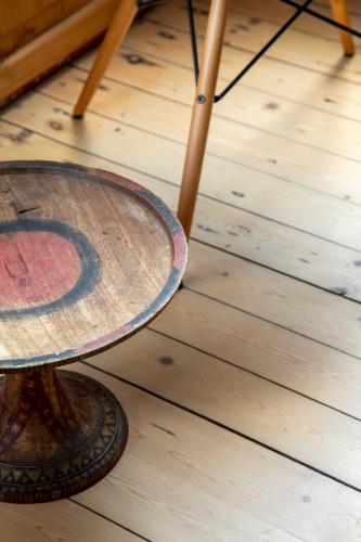 a wooden table sitting on top of a wooden floor at Spacious Belle Epoque House with free parking in Ostend