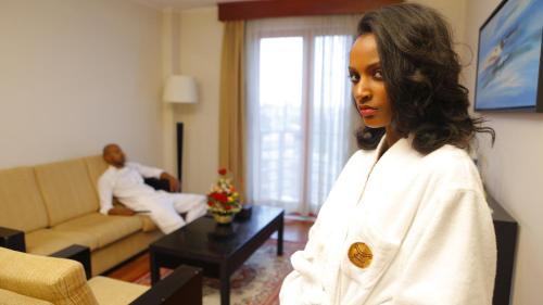 a young woman standing in a living room at Wassamar Hotel in Addis Ababa