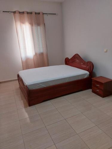 a bedroom with a bed and a dresser in it at Résidence beau-lieu in Yaoundé