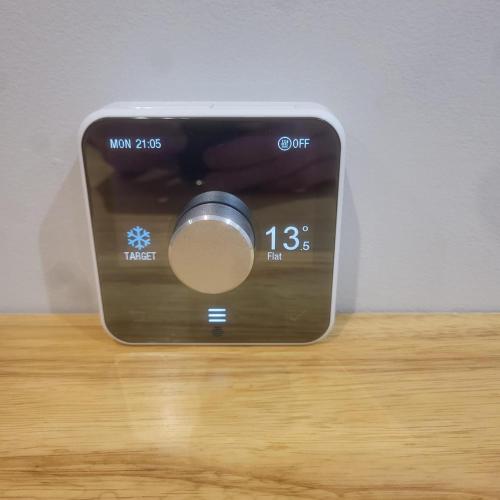 a alarm clock sitting on top of a table at Town Centre Modern 1 Bed self-contained Apartment in Newbury