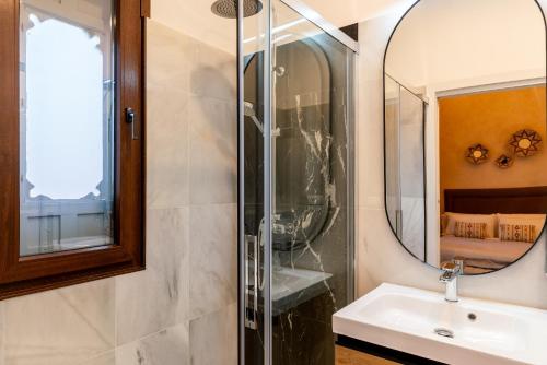 a bathroom with a sink and a mirror at Arco de la Seda - Hotel Boutique in Seville