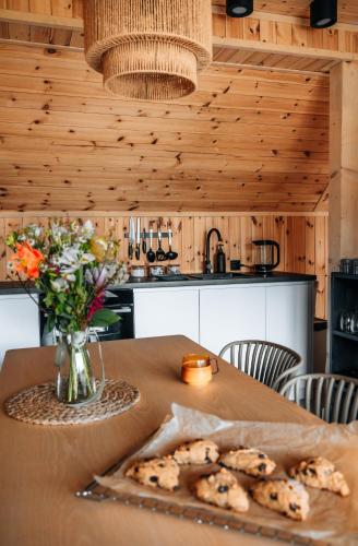 a table with cookies and a vase of flowers at Zen Sasino in Sasino
