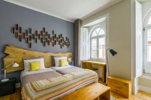 a bedroom with a king sized bed in a room at 19 Tile Ceramic Concept - by Unlock Hotels in Caldas da Rainha
