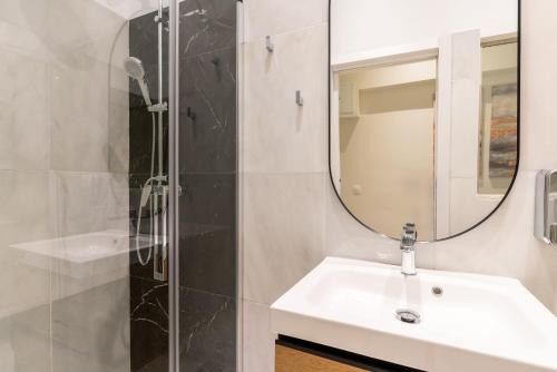 a bathroom with a sink and a mirror at Arco de la Seda - Hotel Boutique in Seville