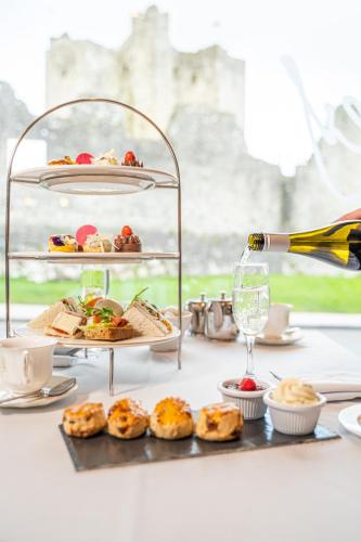 a table with a plate of food and a bottle of wine at Trim Castle Hotel in Trim